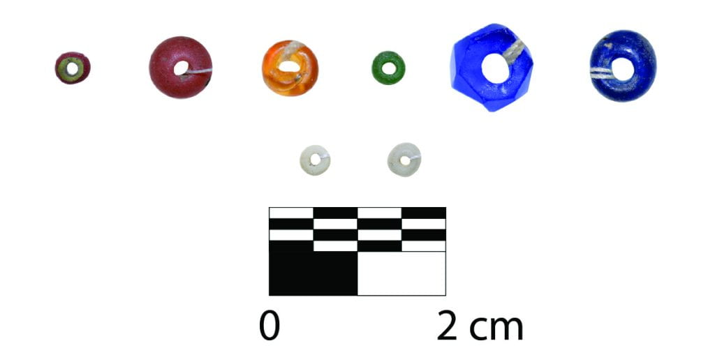 eight glass beads of different sizes